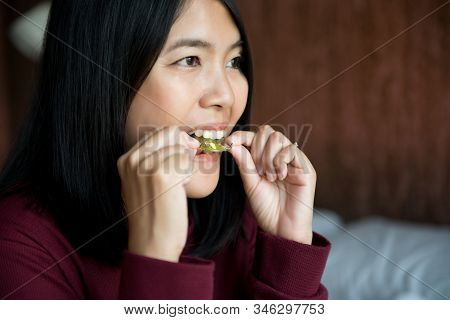 Asian Woman Using Braces Teeth Or Silicone Trainer To Mouth,orthodontic,dental Health Conceptclose U