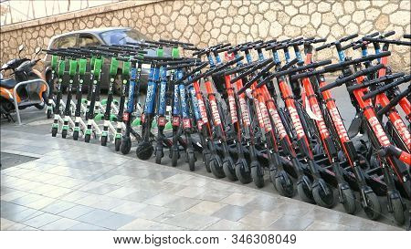 Malaga, Spain: November 23, 2019: Dockless Electric Scooters On The Sidewalk