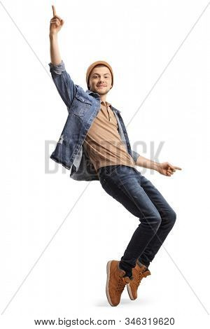 Full length shot of a young guy in casual clothes dancing on tiptopes isolated on white background