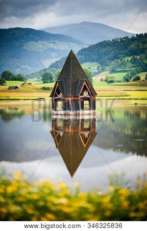 Detail Of Rottenmann Lake Near Schoder, Austria, With Tourist Attraction Church Steeple Emerging Fro