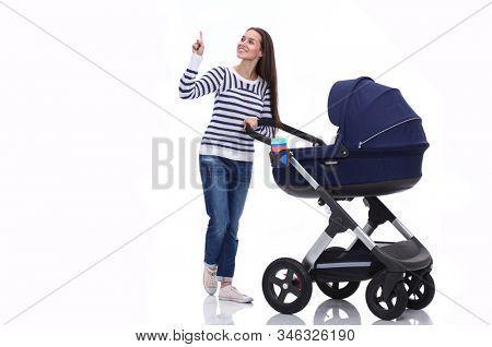 Full length portrait of a mother with a stroller, isolated on white background. Young mom
