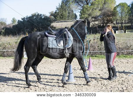 Riding Girl Are Training Her Black Horse