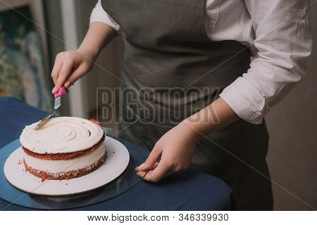 The Confectioner Levels The Cream On The Cake. The Cook Creates A Cake, Collects It And Covers It Wi