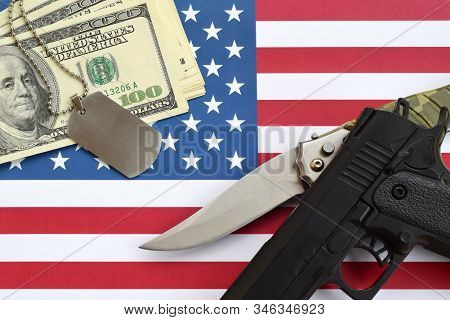 Close Up Dollar Money With Weapons And Military Badges On United States Flag. Military Forces, Finan