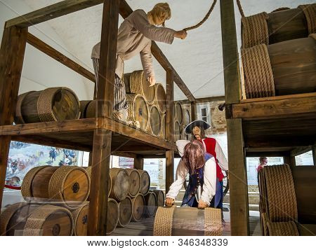 Azov, Russia - July 27, 2019: Reconstruction Of Loading Barrels Of Gunpowder. Powder Cellar Of The A