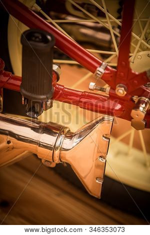 Close Up Of A Vintage Motorcycle Fish Tail Exhaust Pipe.