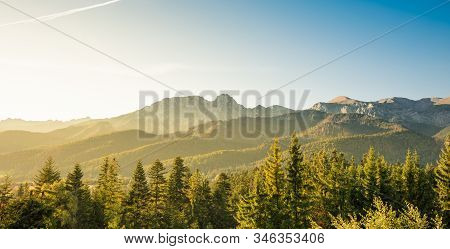 Golden Sunrise, Green Trees And Blue Sky Over Silhouette Of Tatra Mountains In Poland - View From Ko