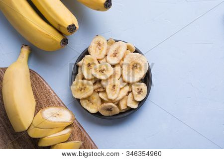 Dehydrated, Dried Banana Chips On Light Background. View From Above.