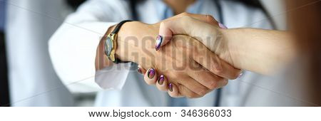 Arm Of Female Gp Shaking Hands With Visitor Close-up. Self Introduction Cheering Or Problem Solution