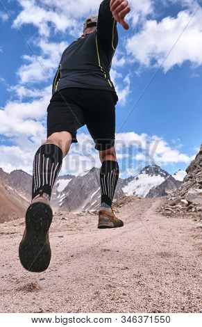 Closeup Of Feet With Running Shoes Of A Trailrunner Man Running In The Mountains Trail