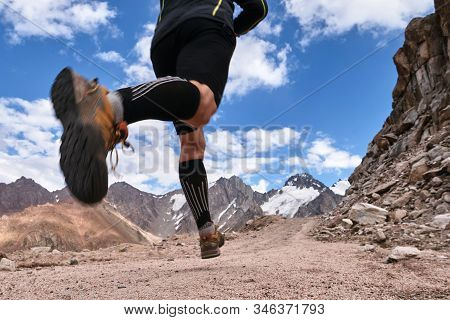 Closeup Of Feet With Running Shoes Of A Trailrunner Man Running In The Mountains Trail