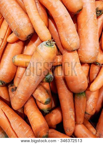Orange Organic Carrots Stacked On Each Other In The Market Grocery Store Ready For Sale As A Part Of
