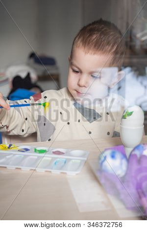 Toddler Boy Painting Easter Eggs Preparing For Holidays. Easter Tradition