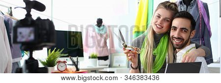 Fashion Industry Blog Content Clothes Creation. Blond Seamstress With Scissors And Handsome Caucasia