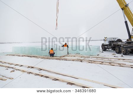 Slingers In Special Winter Overalls For Shipment Of Ice Blocks