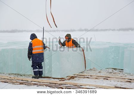 Slingers In Special Winter Overalls For Shipment Of Ice Blocks