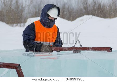 Slinger In A White Helmet On A Shipment Of Ice Blocks