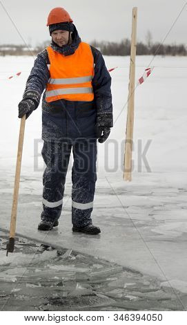 A Working Installer In A Life Jacket Rafts Ice Panels To A Lane With A Hook