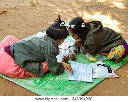 Bagan, Myanmar - February 03, 2019:  Two Young Myanmese Girls Doing Their School Homework In The Vic