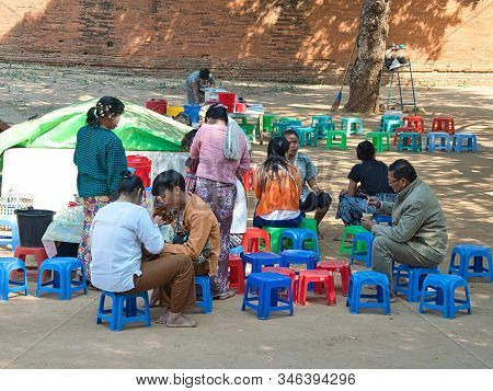 Bagan, Myanmar - February 03, 2019:  Myanmese People Eating Local Dessert In The Area  Of The Ancien