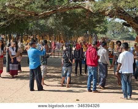 Bagan, Myanmar - February 03, 2019:  People And Tourists Looking At The Traditional Burmese Puppets 
