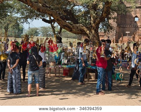 Bagan, Myanmar - February 03, 2019:  People And Tourists Looking At The Traditional Burmese Puppets 