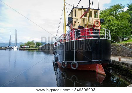 Old Steel Ship With Black Hull Docked At Crinan Channel, Scotland