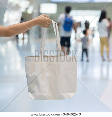 Woman Hand Holding Eco Shopping Bag In Store Background With Copy Space For Text. Environmental Prot