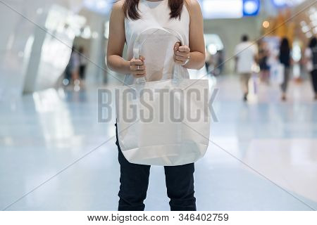 Woman Hand Holding Eco Shopping Bag In Store Background With Copy Space For Text. Environmental Prot