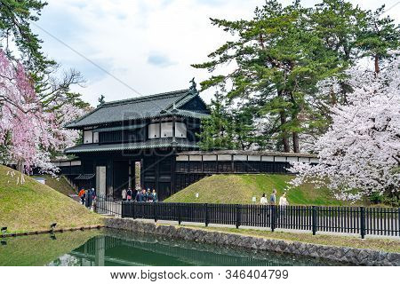 Hirosaki Park In Springtime Cherry Blossom Season Sunny Day At Otemon Gate Entrance. Visitors Enjoy 
