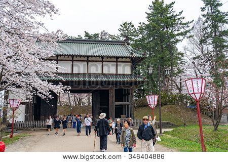 Hirosaki Park In Springtime Cherry Blossom Season Sunny Day At Otemon Gate Entrance. Visitors Enjoy 