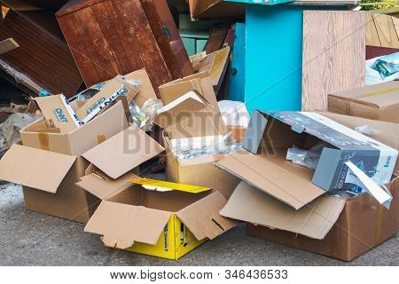 A Lot Of Empty Cardboard Boxes, Old Wooden Furniture In The Backyard: Ufa, Russia - May 30, 2019.