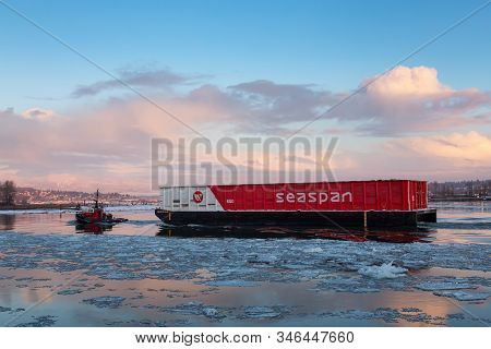New Westminster, Vancouver, Bc, Canada - January 16, 2020: Industrial Tugboat Pulling A Load In Fras