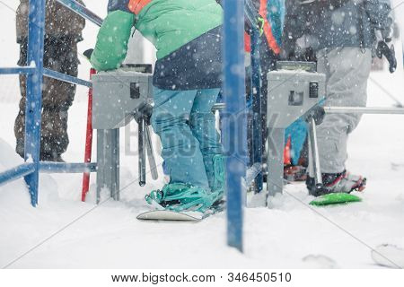 People Is Using A Ski Pass Card On The Lift Line At A Ski Resort In Winter Blizzard.