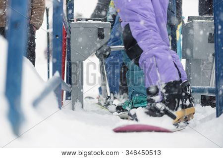 People Is Using A Ski Pass Card On The Lift Line At A Ski Resort In Winter Blizzard.