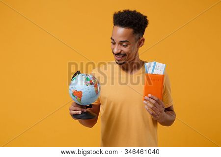 Smiling Young African American Guy In Casual T-shirt Posing Isolated On Yellow Orange Wall Backgroun