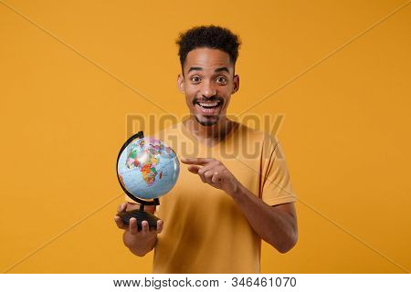 Funny Young African American Guy In Casual T-shirt Posing Isolated On Yellow Orange Wall Background 