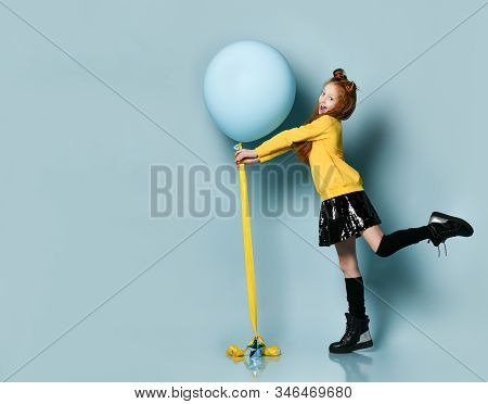 Ginger Teenage Kid With Fancy Hairstyle In Yellow Sweatshirt, Black Skirt, Knee-highs, Boots. Smilin