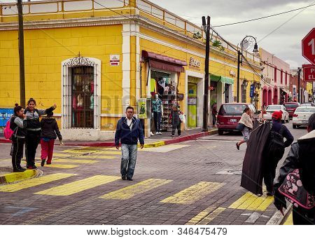 San Pedro Cholula, Mexico, October 17, 2018 - Yellow Pedestrian Crossing With People Walking And Man
