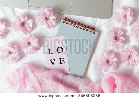 Flay Lay, Top View Office Table Desk. Feminine Desk Workspace Frame With Sakura Flowers On White Bac