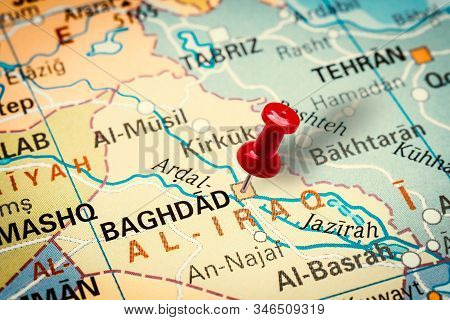 Prague, Czech Republic - January 12, 2019: Red Thumbtack In A Map. Pushpin Pointing At Baghdad City 