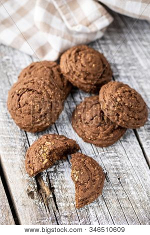 Cereal cocoa cookies on old wooden table.