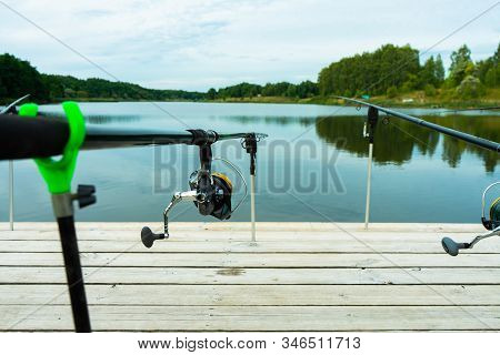 Carp Fishing On Beautiful Blue Lake With Carp Rods And Rod Pods In The Summer Morning. Fishing From 
