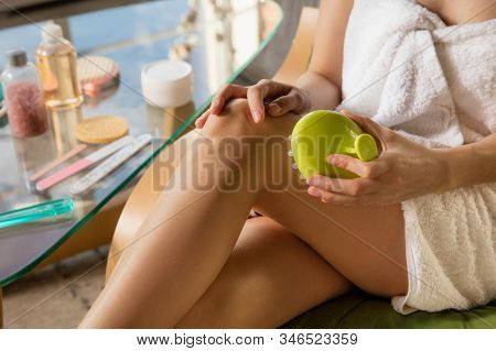 Beauty Day. Woman Wearing Towel Doing Her Daily Skincare Routine At Home. Putting On Moisturizing, D