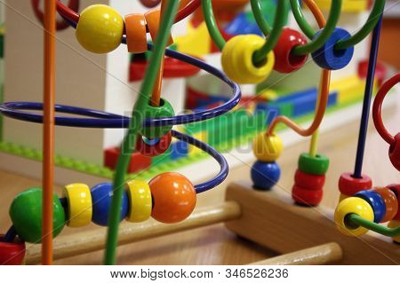 The colored plastic cubes, puzzles for children. The colored balls attraction on the table. Games, toys, mosaic, puzzle for the development of mental abilities and logical thinking of kids