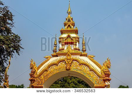 Decoration On The Gate Of Wat Khu Kum With The Statues Of Buddha, Naga, And Garuda In Muang District