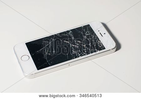 Modern Smartphone With Seriously Broken Display Screen Isolated On White Background.
