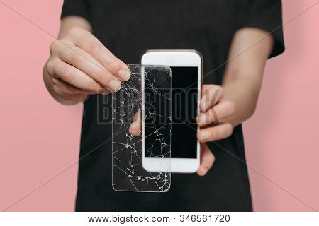 Worker Of Service Center Demonstrates Benefit Of Using Protection Screen Cover For Smartphone. Displ