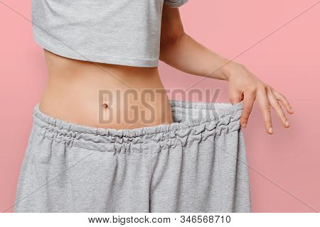Young Fit Woman In Her Old Clothes Shows How Much Weight She Lost. Successful Result Of A Diet And S