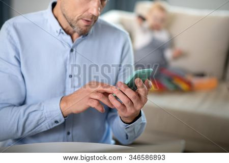 Bearded Man In A Blue Shirt Tping A Message